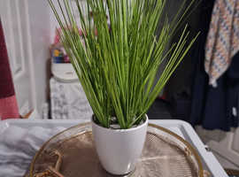 Faux plant in white pot