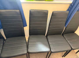 4 dining chairs black in color