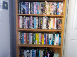 Pine bookcase housing wide collection of boxed Video tapes