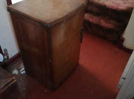 Vintage Treadle type Singer sewing machine in cabinet.
