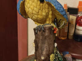 STILL AVAILABLE Large yellow/blue Parrot Ornament mounted on a ceramic terracotta stand