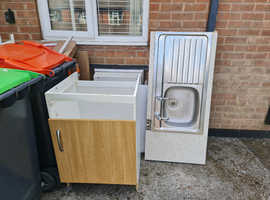 Kitchen sink and worktop and cupboard.