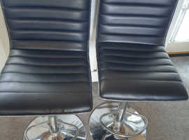 2 Black upholstered swivel chairs