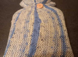 Hot water bottle with knitted cover