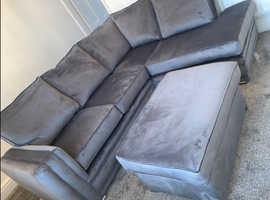 Grey plush velvet sofa with footstool