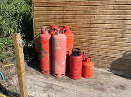 7 empty gas bottles