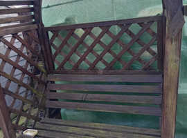 BENCH  ABOUT 3SEATS  WOOD WITH ARCH OVER TO.  .WITH TRESTLE SIDES