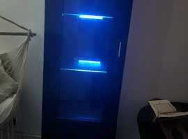 Tall, glossy black elegant display cabinet with LED lighting.