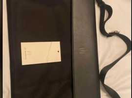 Black LA MANSIO computer bag with an adjustable strap