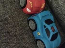 Two flashing light toy cars
