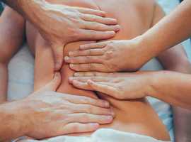 Male and female couple offering 4hand massage