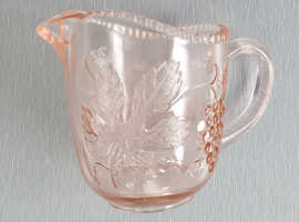 A Small Vintage Glass Jug with Orange Hues.  3.1/2" Tall.