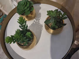 3 golden planters with artificial plants