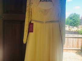 Beautiful pale yellow lace dress. Never worn. Bought in the hope I would slim in to it but sadly failed!