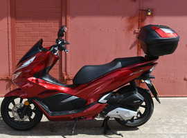 A very well cared for Honda PCX scooter.