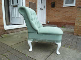 Mothering chair, upholstered in light green.