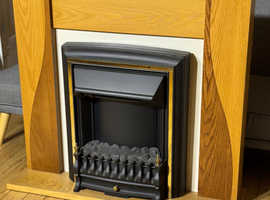 Electric Fire with surrounding wooden fireplace