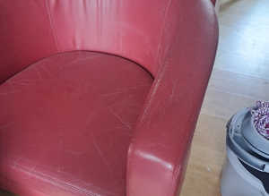 Matching pair red leather arm chairs