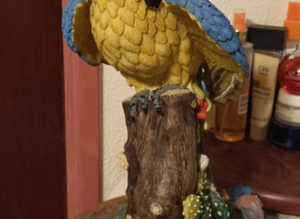 STILL AVAILABLE Large yellow/blue Parrot Ornament mounted on a ceramic terracotta stand
