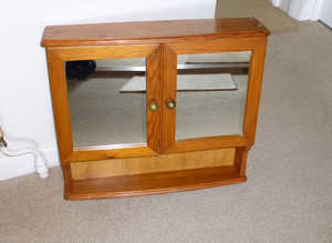 Bathroom cabinet with 2 shelves inside.