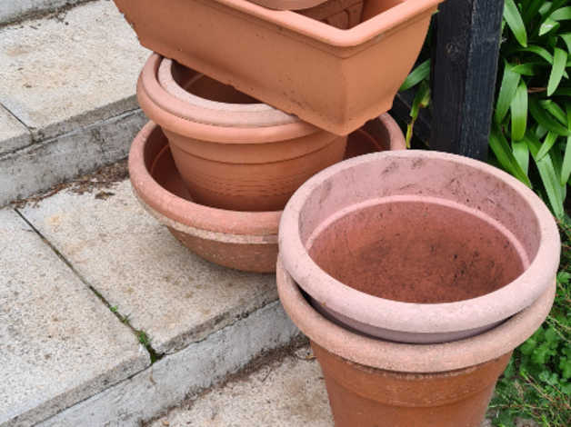 An assortment of Glazed brown plastic plant pots in Grampound