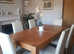Medium oak dining table and 6 high back leather chairs