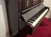 Upright piano and stool by Dallinson & co